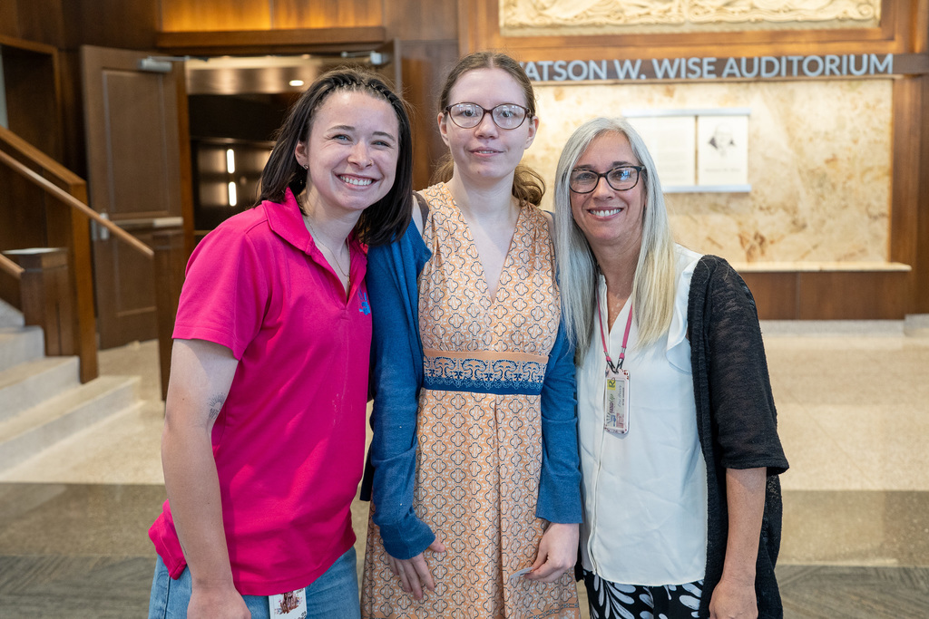 LINK 18+ Graduate smiles with teachers.