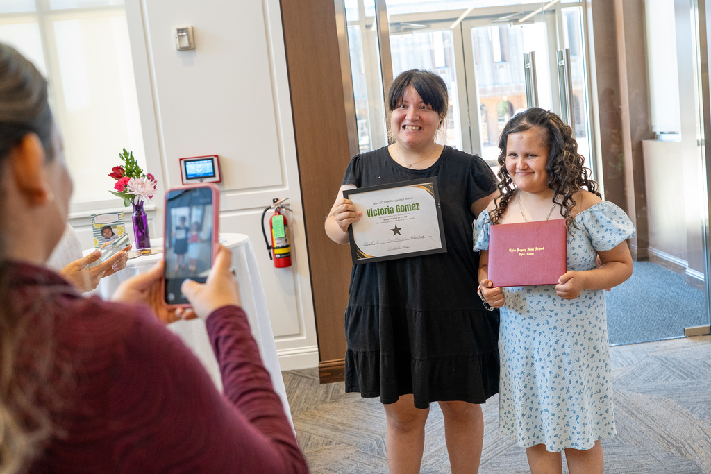 LINK 18+ Graduates smile together with certificates.