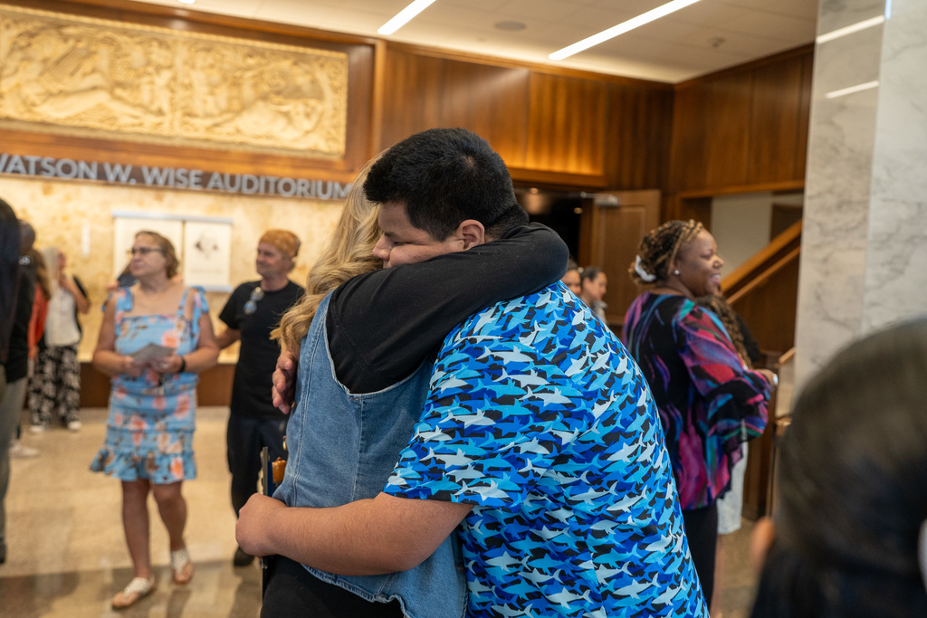 LINK 18+ Graduate hugs teacher.