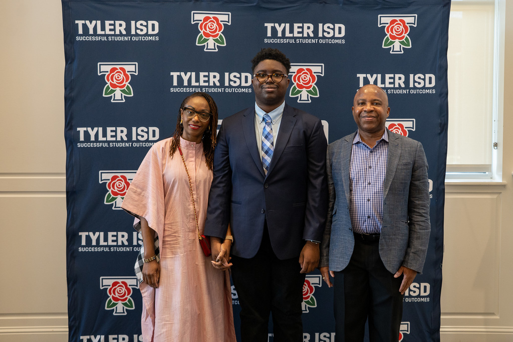 LINK 18+ Graduate smiles with family.