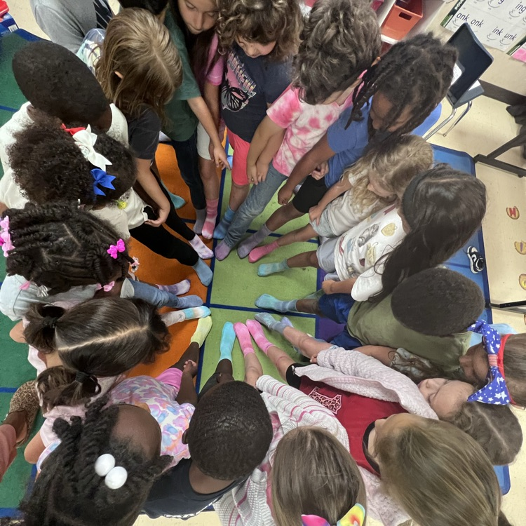 student standing in a circle wearing tie-dye socks