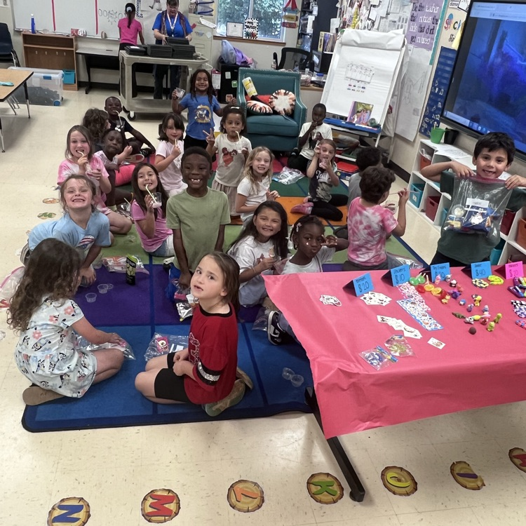 Students enjoying their prizes they purchased on the carpet
