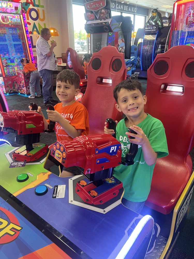 kinder at Chuck E Cheese playing games