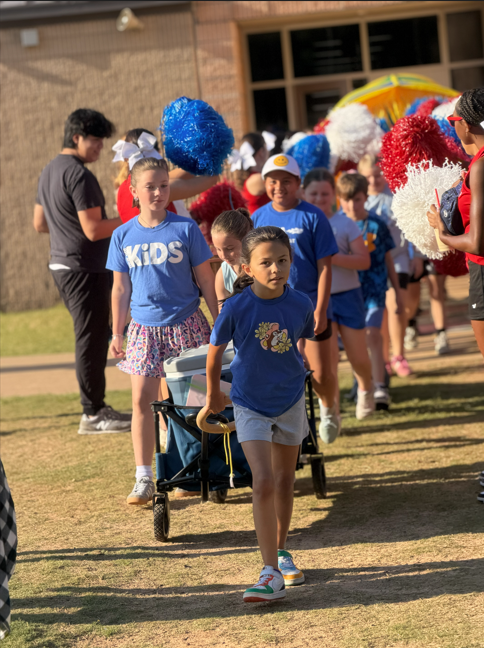Students walking to the field with field day shirts on.