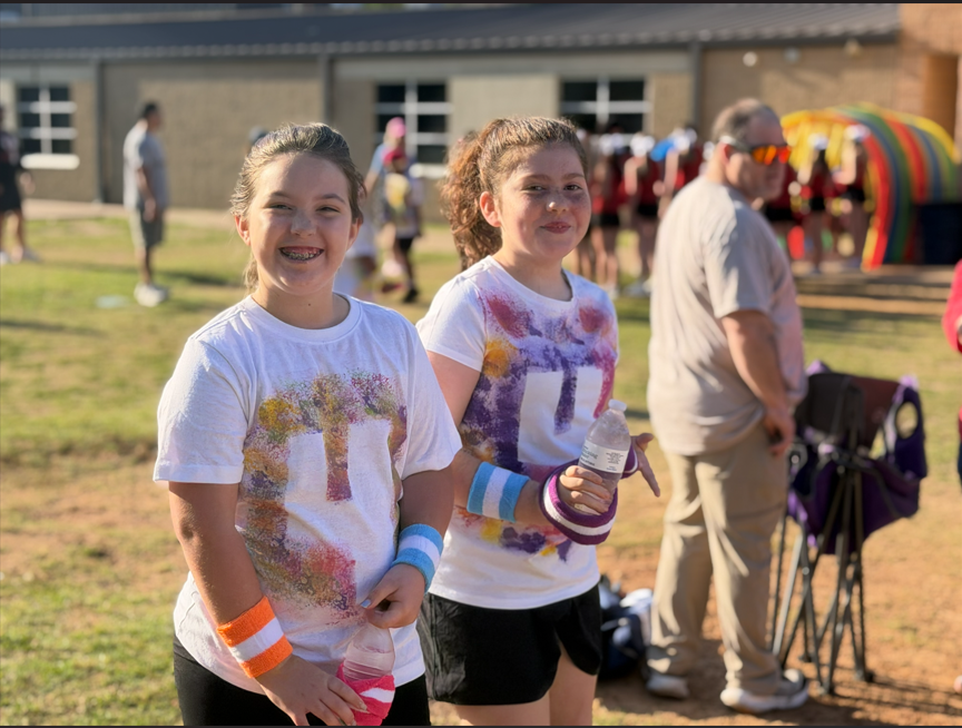 Students walking to the field with field day shirts on.
