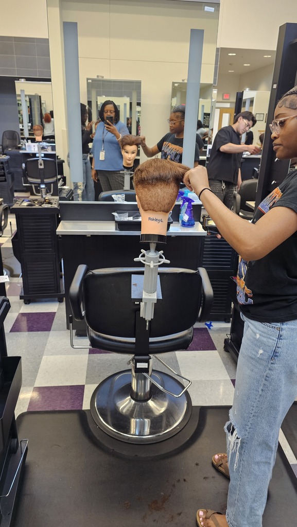 Tyler ISD Career & Technology Center cosmetology student practicing cutting hair.