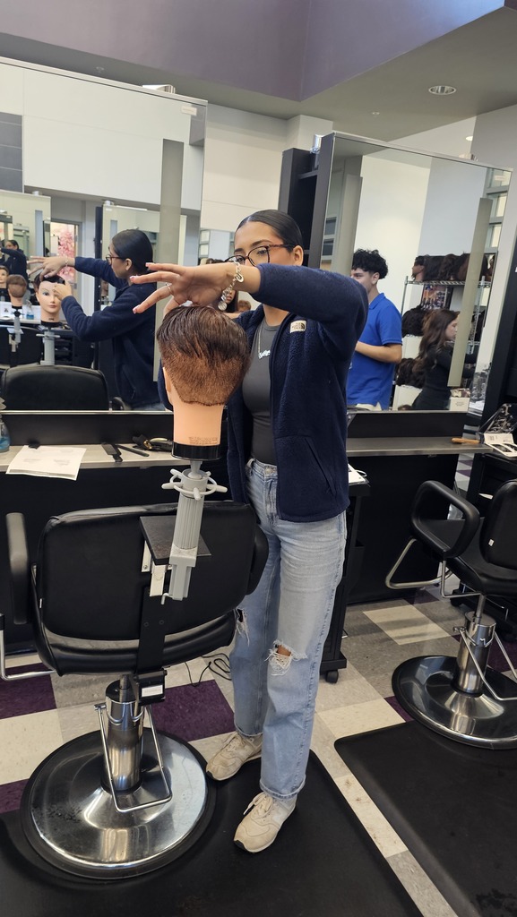 Tyler ISD Career & Technology Center cosmetology student practicing cutting hair.
