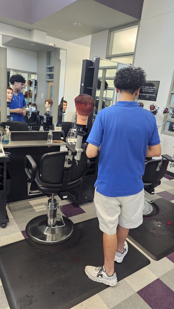 Tyler ISD Career & Technology Center cosmetology student practicing cutting hair.