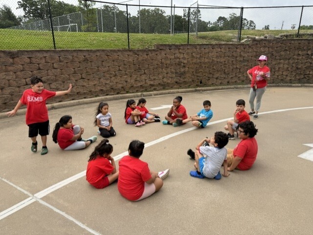 a group of children playing duck duck goose