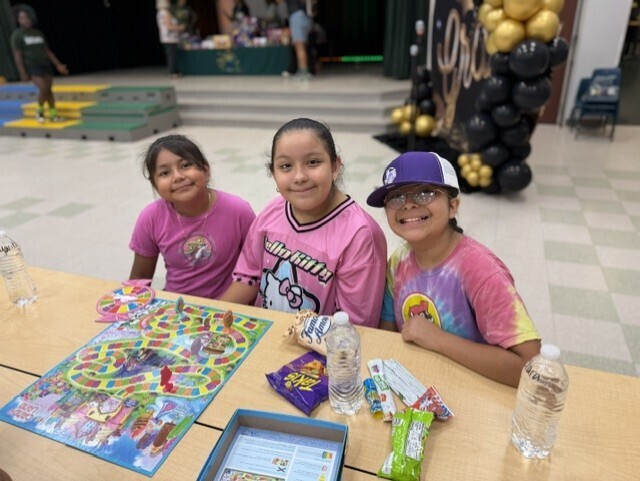 three girls smiling playing candyland