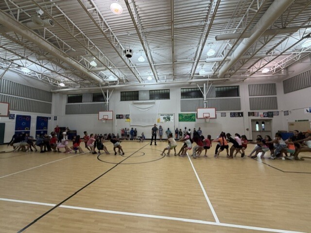 a gym full of kids playing tug a war