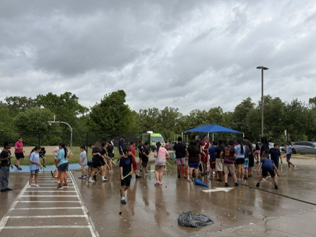 a group of kids playing water games outside