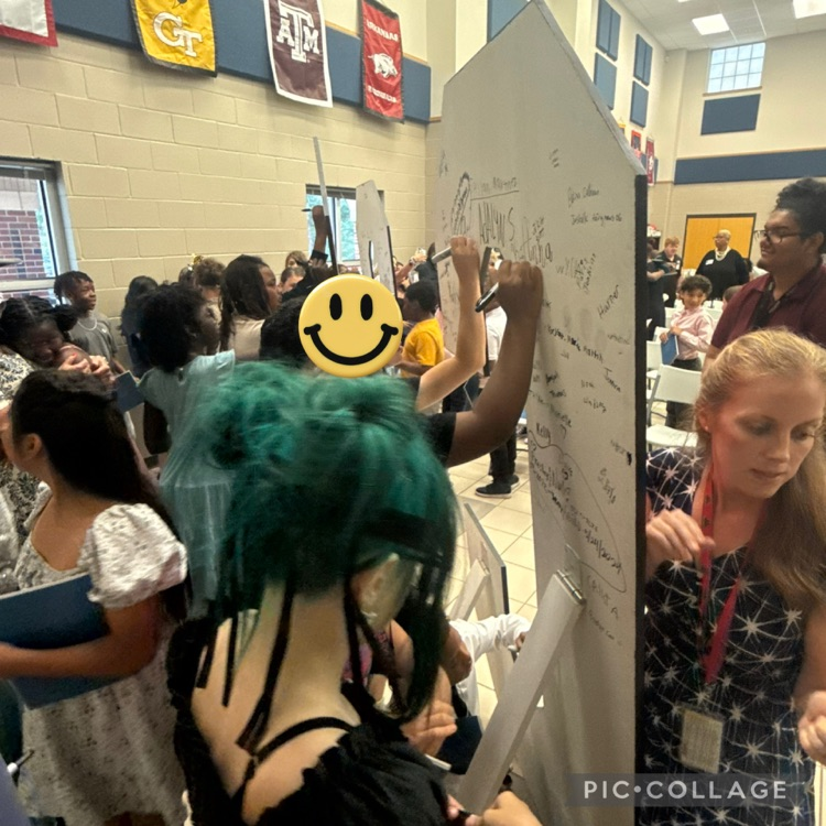 students signing their names on the back of C E S letters