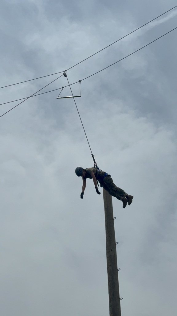 kid swinging from pole