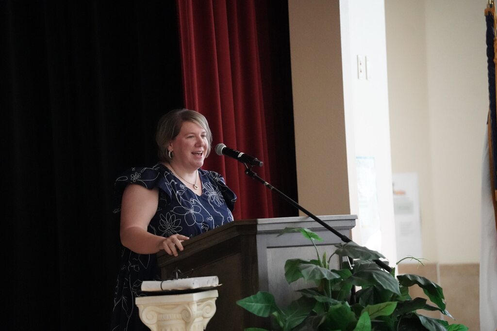 Principal at the microphone leading the graduation ceremony