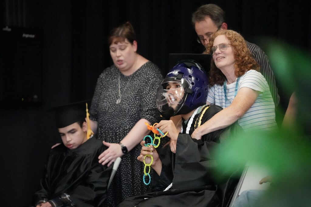 Graduate singing along to the school song