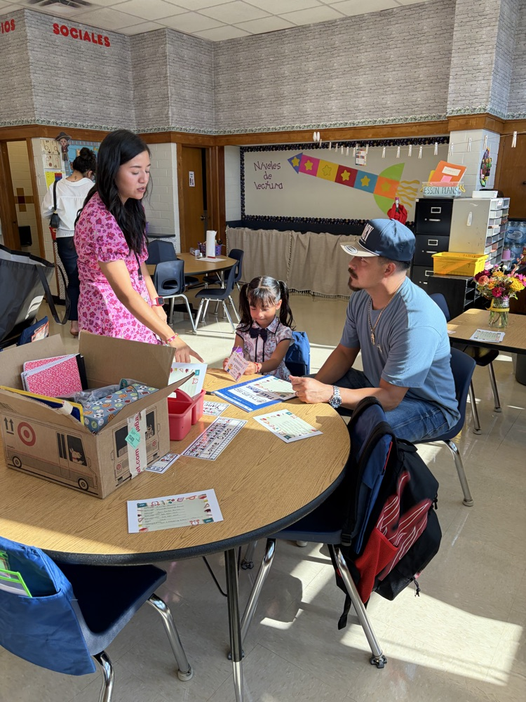 students at Meet the Teacher at a table