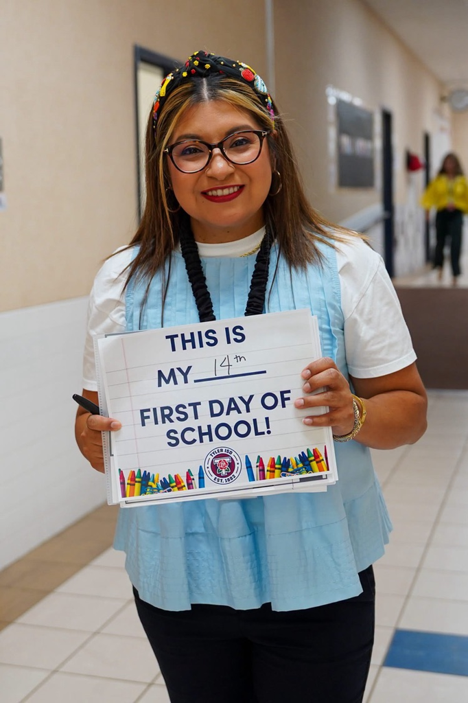 teacher holding sign