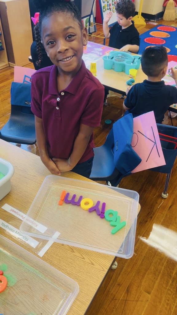 child at table with letters
