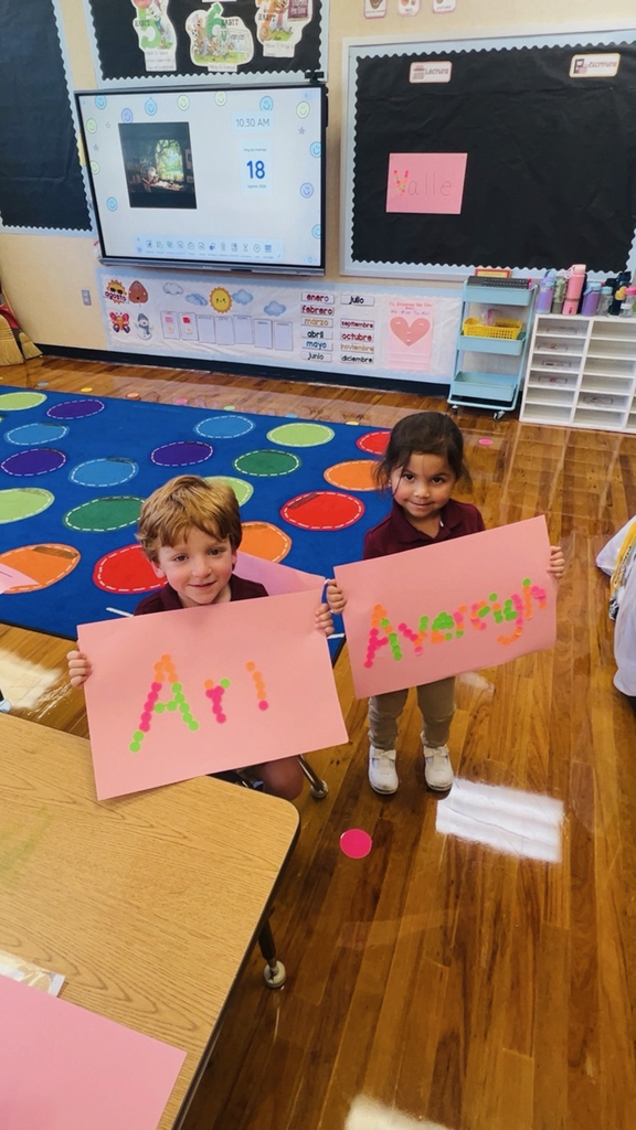 child at table with letters