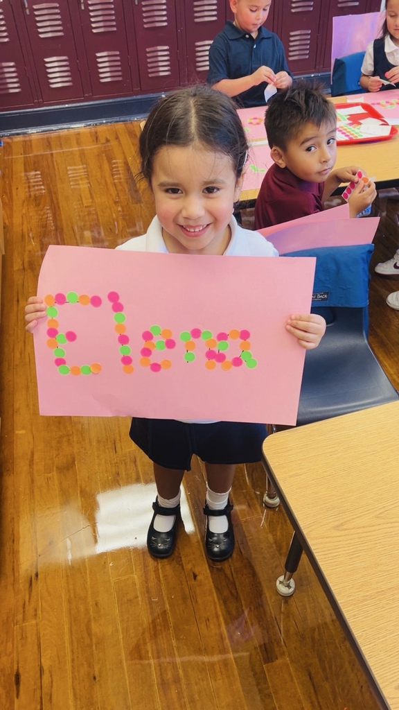 child at table with letters