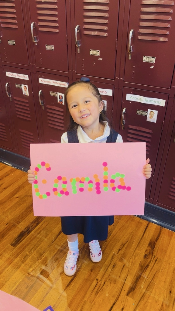 child at table with letters