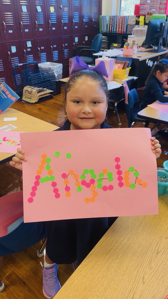 child at table with letters