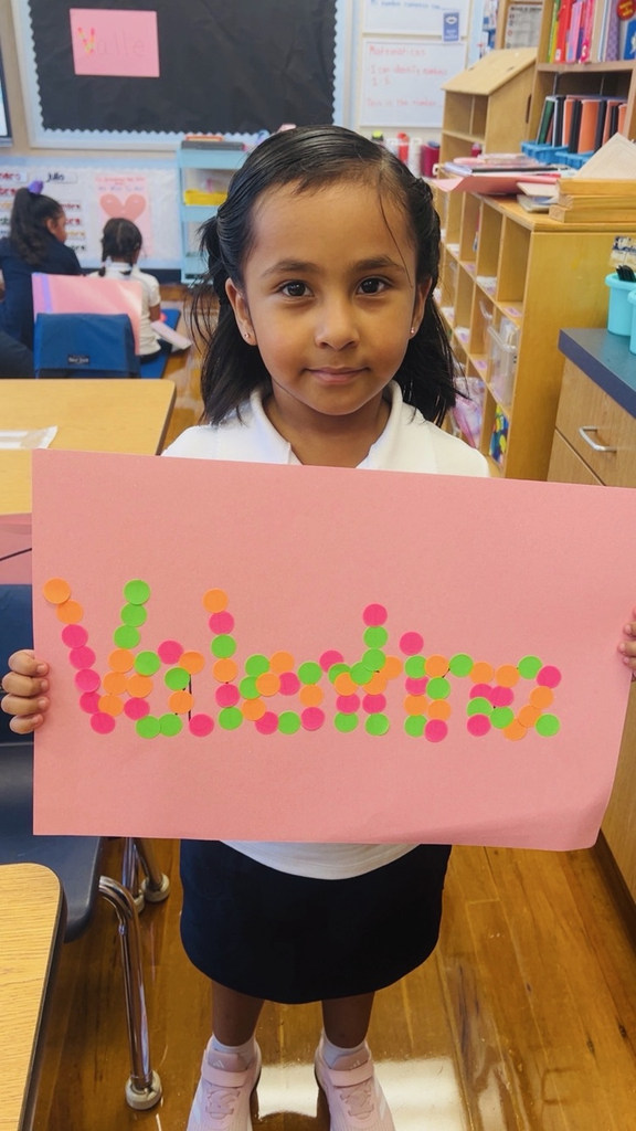 child at table with letters