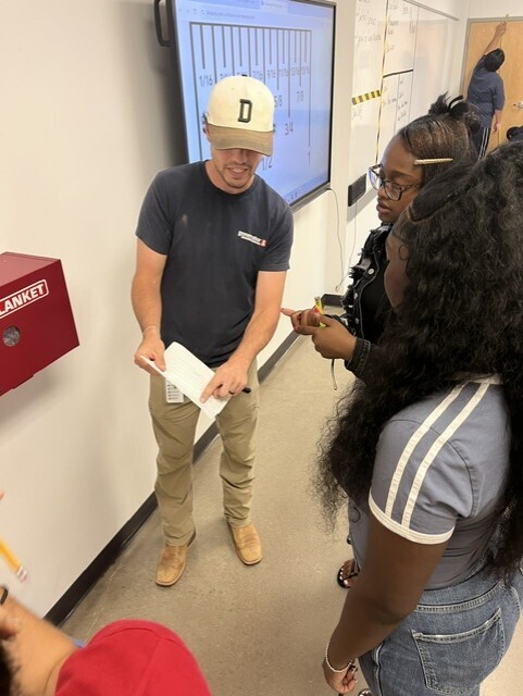 Teacher explaining measuring to students