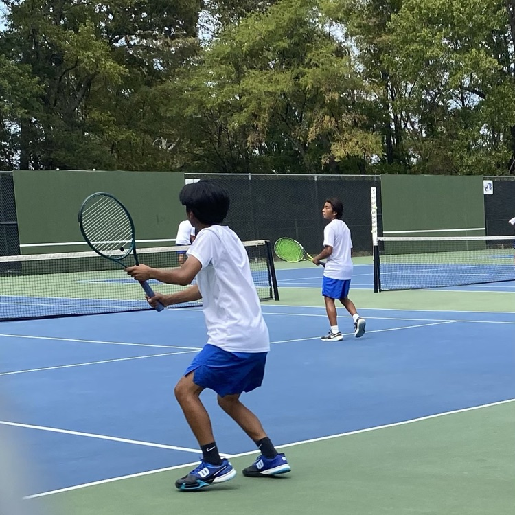 doubles tennis team on court