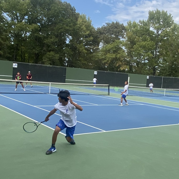 tennis player going after ball