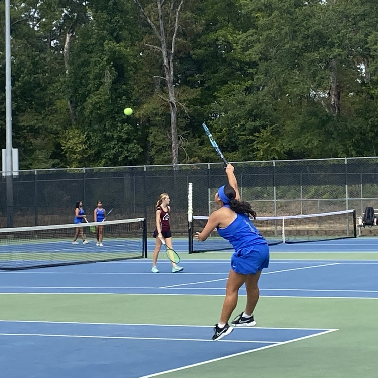 tennis player hitting ball