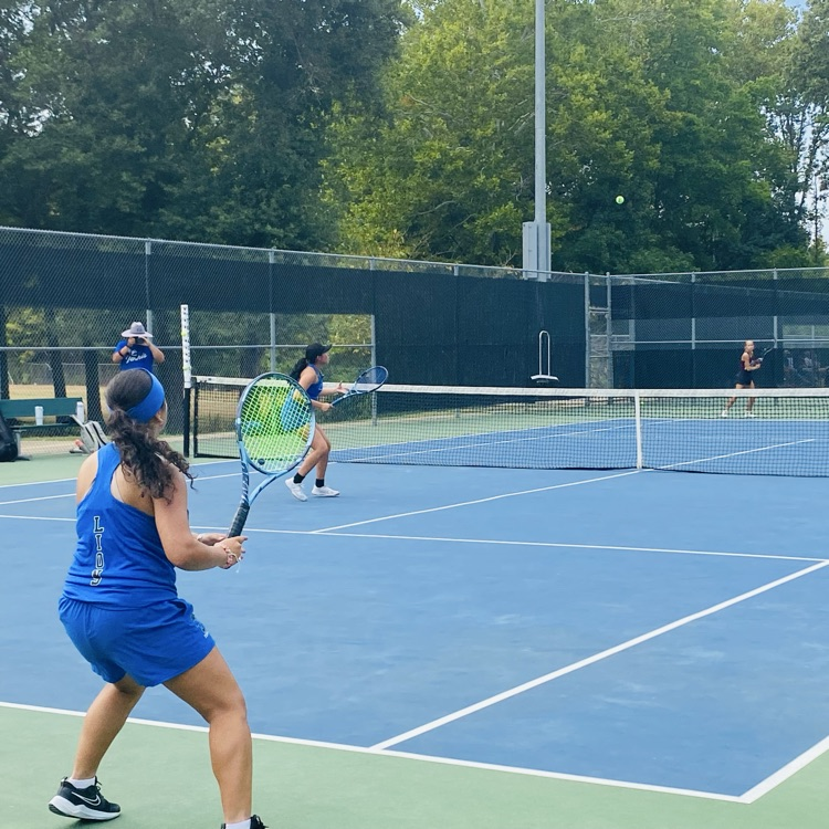 tennis doubles team playing