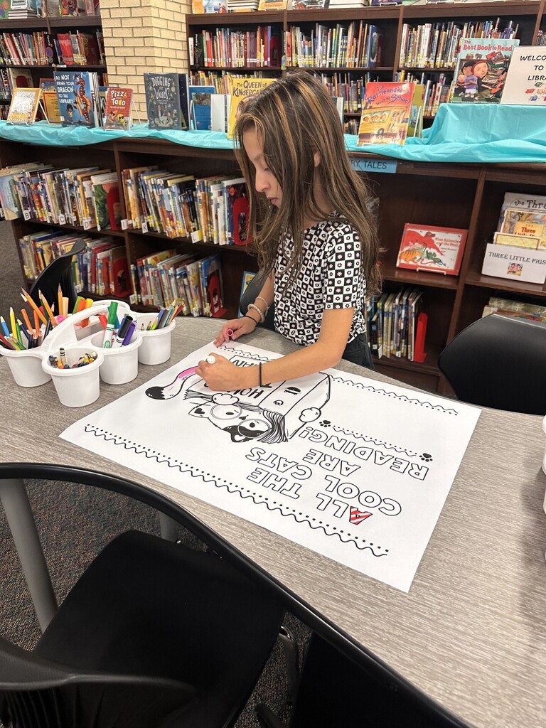 a student coloring a giant coloring page