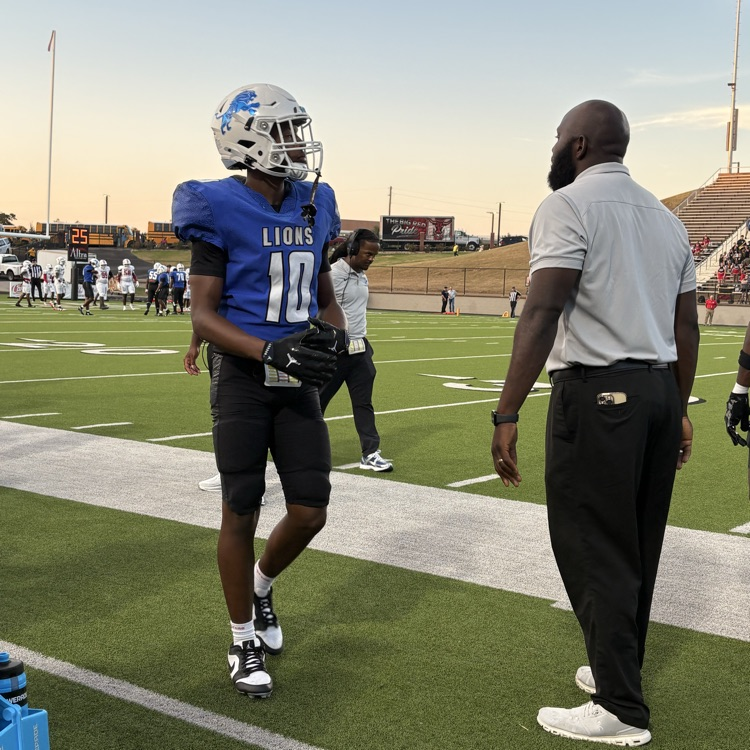 football players and coaches on the sidelines 