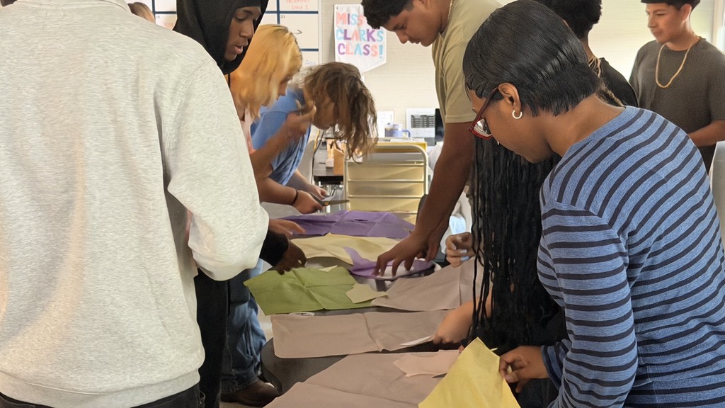 students cutting patterns in a Guilded Age workshop