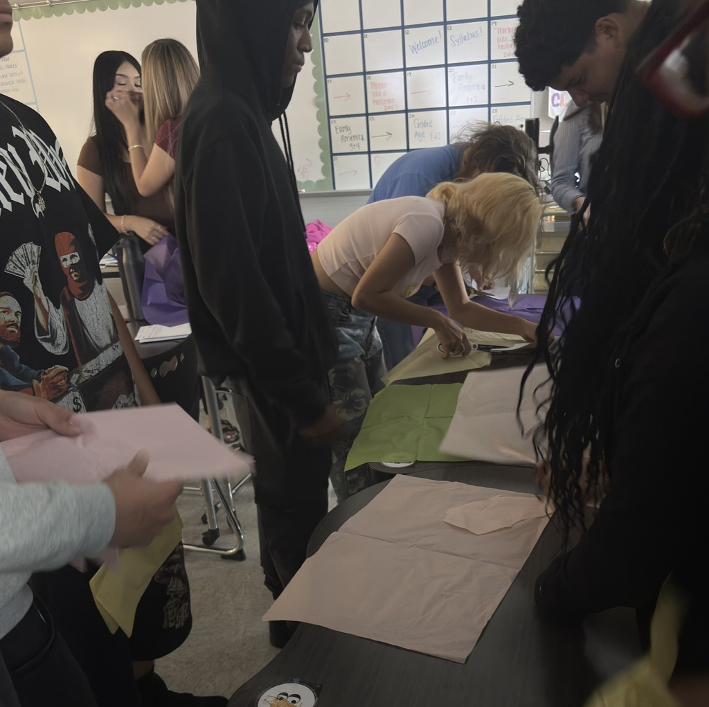 students cutting patterns in gilded age workshop