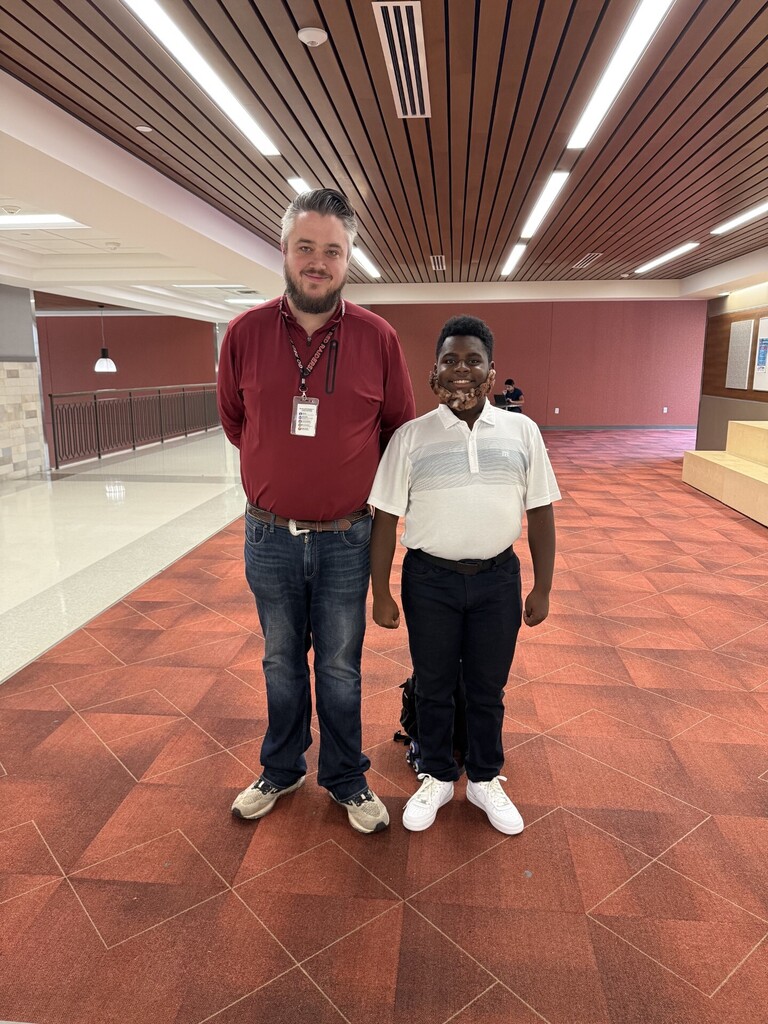 Teacher standing by a student for spirit week