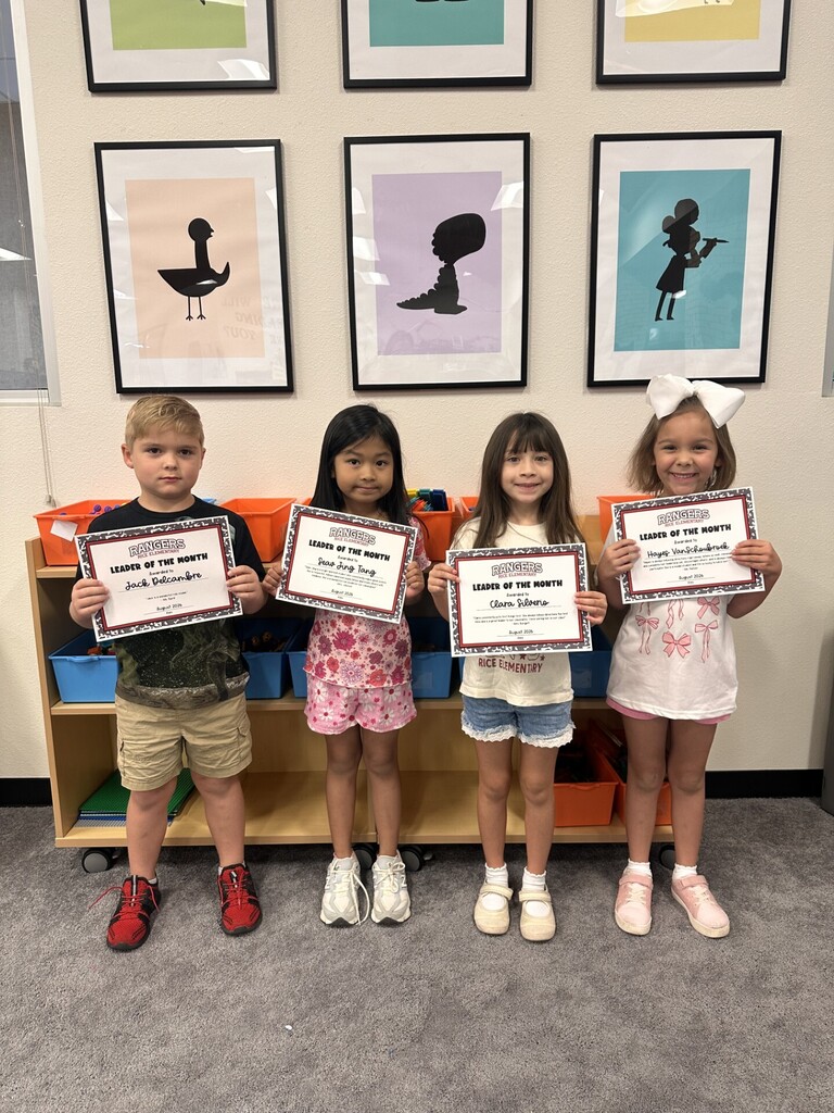 students holding certificates for leader of the month
