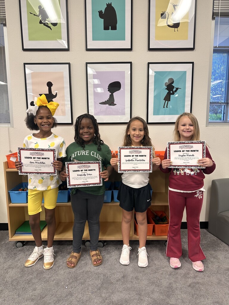 students holding certificates for leader of the month