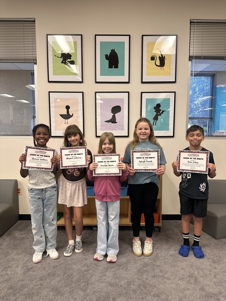 students holding certificates for leader of the month