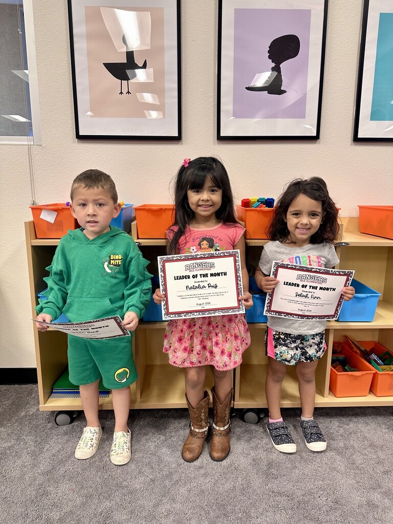 students holding certificates for leader of the month