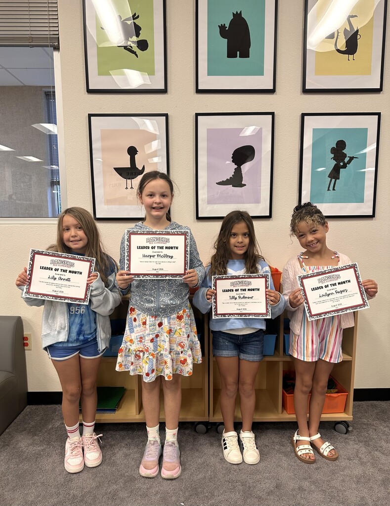 students holding certificates for leader of the month