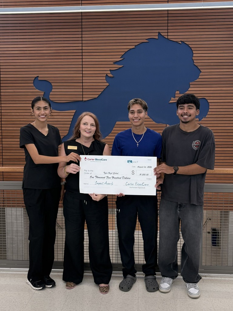 students holding a check from carter bloodcare