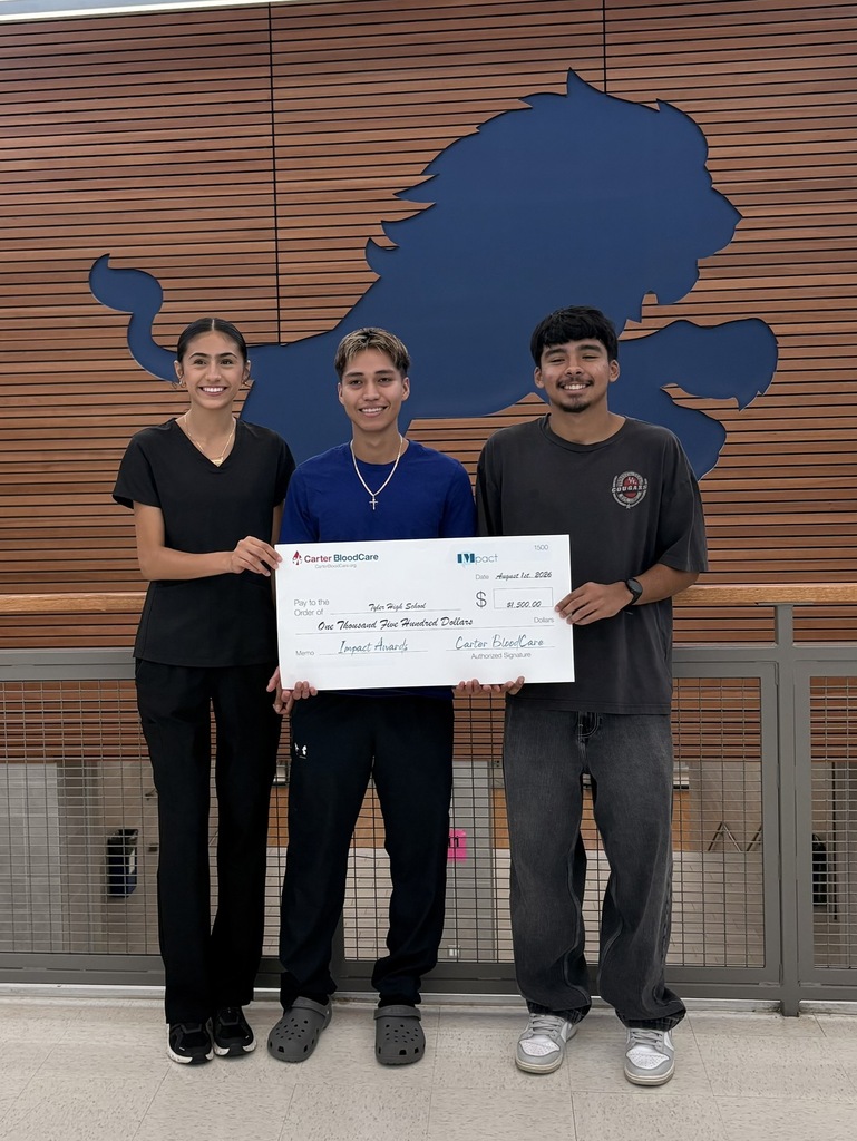students holding a check from carter bloodcare