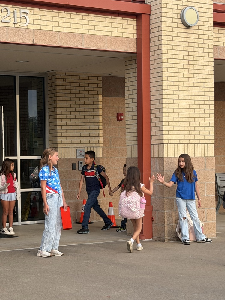 Friday friends welcoming students into school