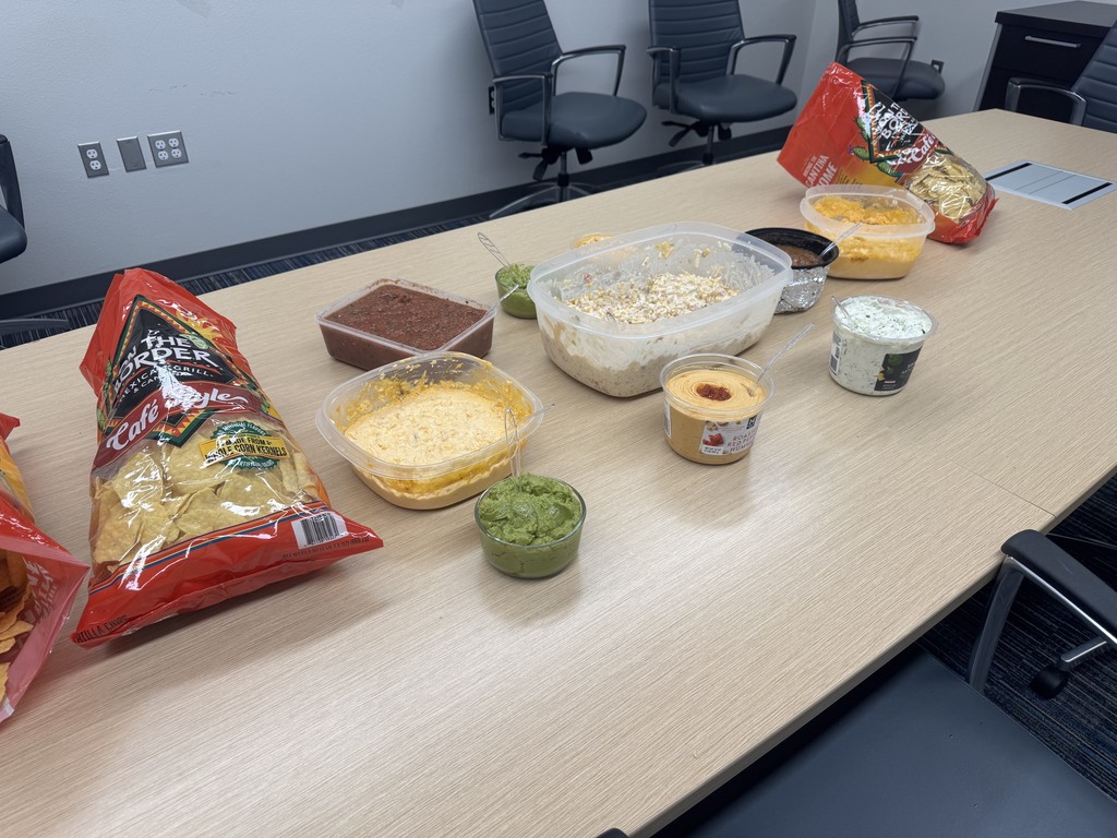 table full of chips and dips