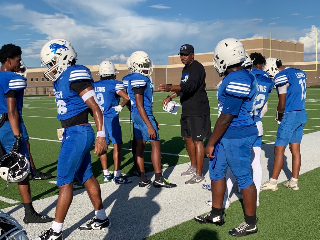 football players on the sidelines leaving huddle