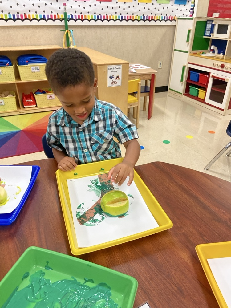 Kid doing an Apple activity