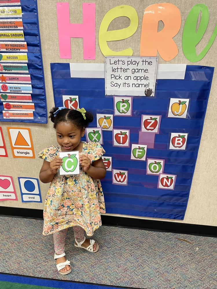 Kid doing an Apple activity.